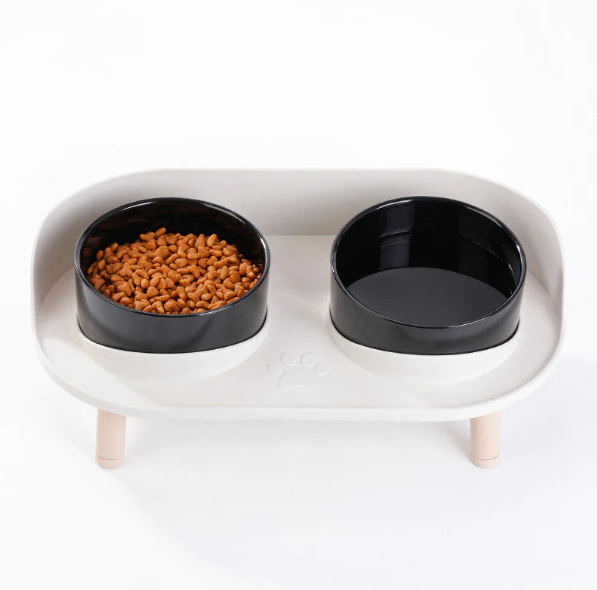 Close-up of black bowl filled with kibble on raised stand — removable, easy clean.