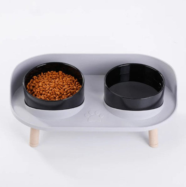 Light gray base with black bowls — left bowl water, right kibble.