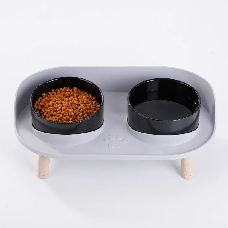 Close-up top view — black bowls with kibble in left bowl.
