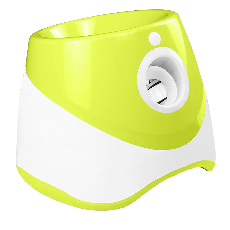 Automatic dog ball launcher, chartreuse/white model—front-left view with hopper and outlet.