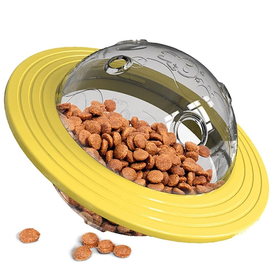 Yellow slow pet feeder/interactive toy with a transparent lid filled with dog food on a white background