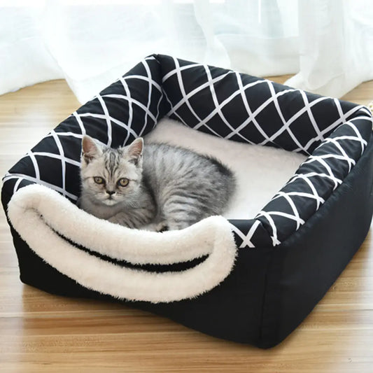 Black sofa-style plush pet bed with white rim — cat lounging comfortably.